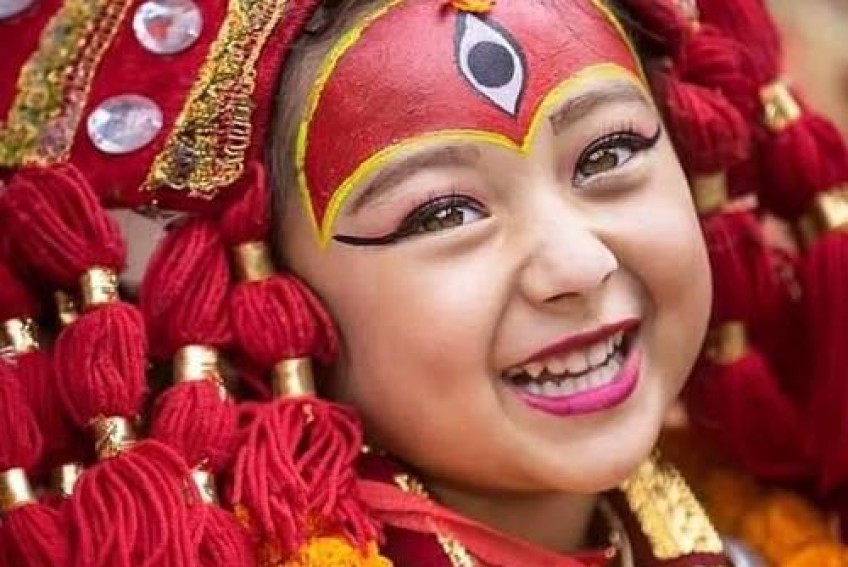 Why is the young girl worshipped as a living Deity, Kumari, in Nepal?